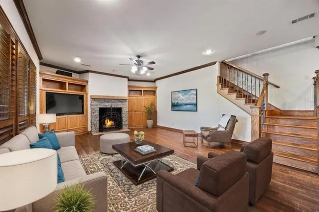 a living room with furniture a fireplace and a flat screen tv