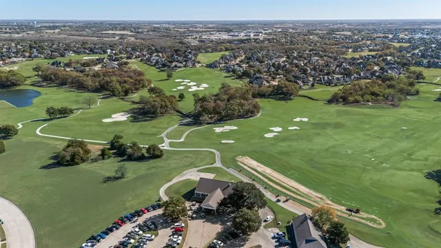 an aerial view of a golf course with parking space