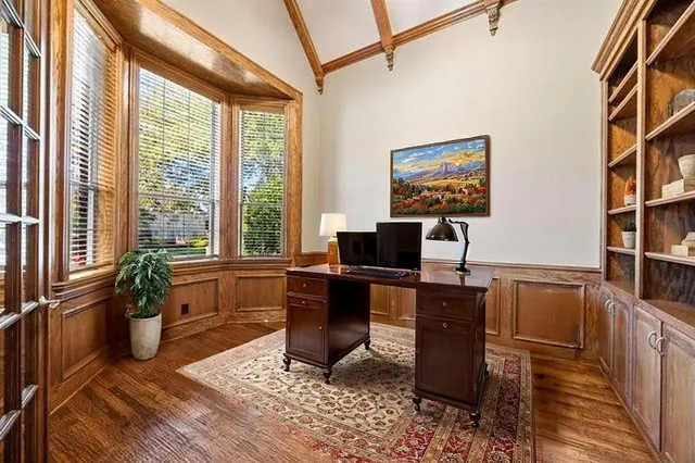 a view of a workspace with furniture and a window