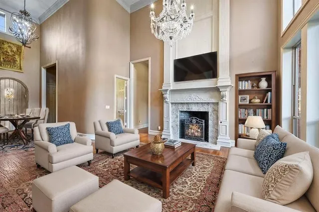 a living room with furniture a flat screen tv and a fireplace