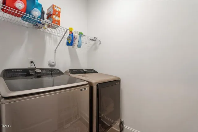 a view of a house with a yard and a large tree