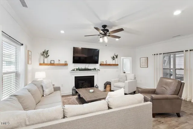 a living room with furniture a fireplace and a flat screen tv