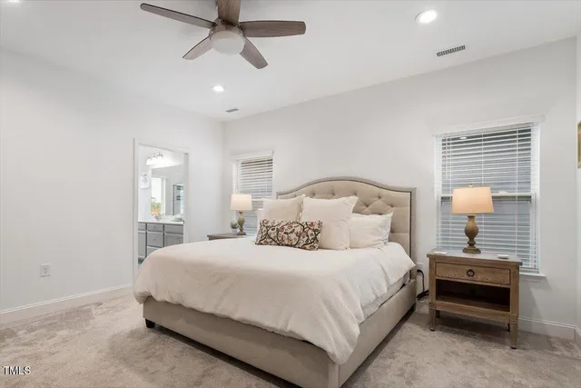 a bedroom with a bed and a lamp