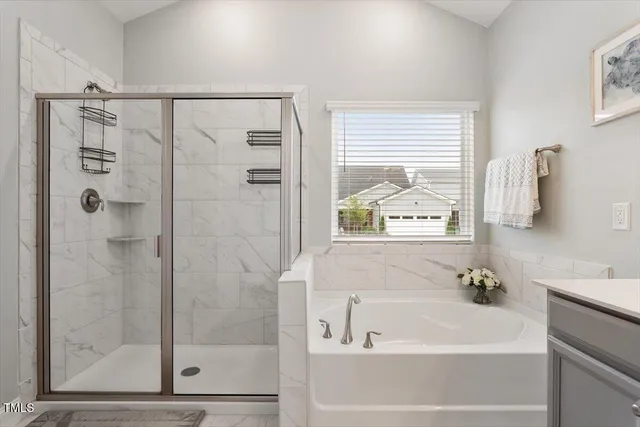 a bathroom with a bathtub and a shower