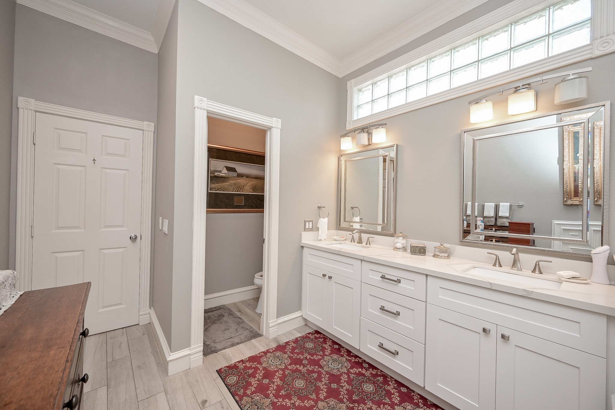 2301 Steel Street Houston, TX 77098 - Photo 18 of 34 Primary bathroom with two sink, tub, sperate shower, and wood like tile floor.