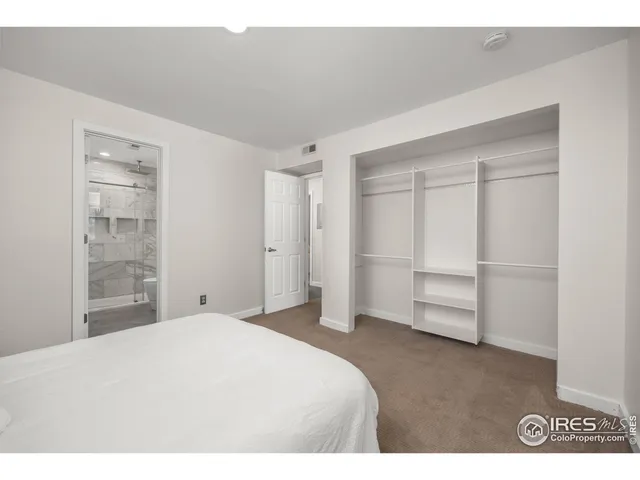 a bedroom with a bed and a cabinets