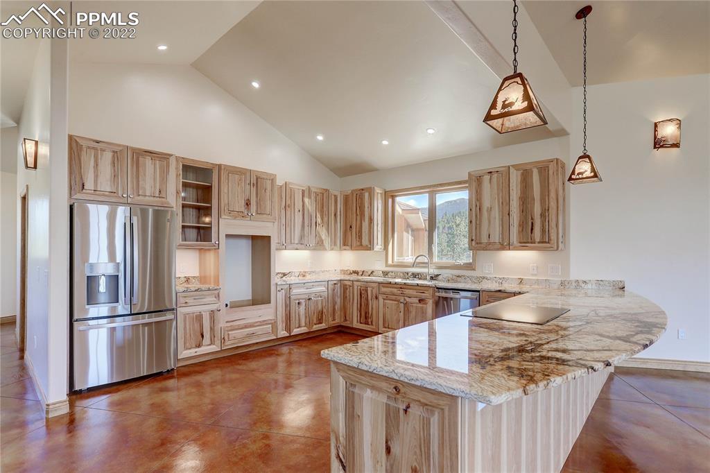 56801 US Highway 285 Bailey, CO 80421 - Photo 17 of 29 a kitchen with stainless steel appliances granite countertop a refrigerator a stove and a wooden floors