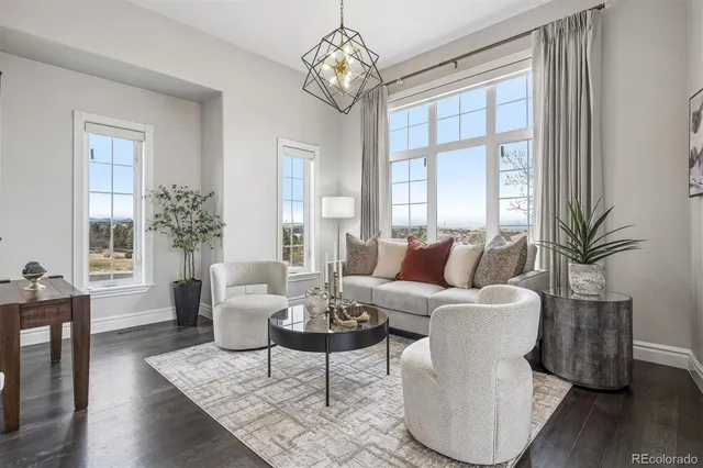 a view of a dining room with furniture a chandelier and wooden floor