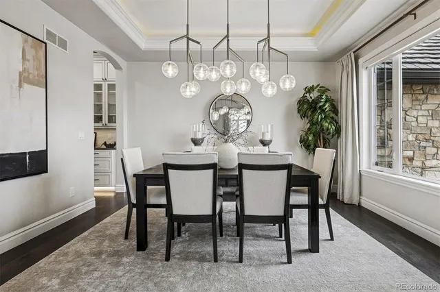 a kitchen with a white cabinets and wooden floor