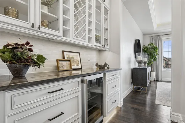 a kitchen with stainless steel appliances granite countertop a table chairs stove and kitchen view