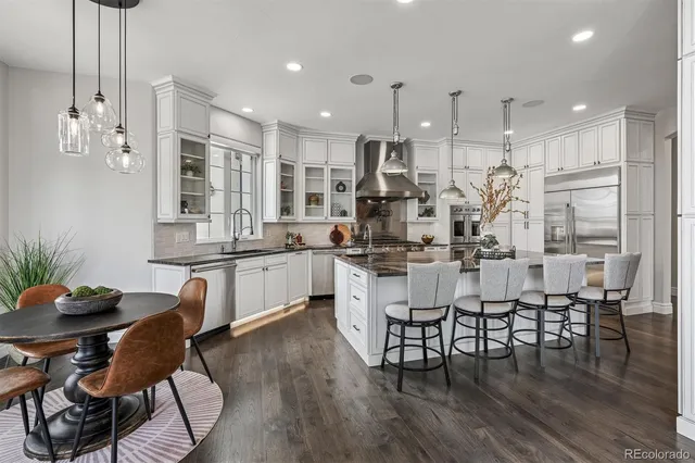 a kitchen with stainless steel appliances granite countertop a stove and a sink