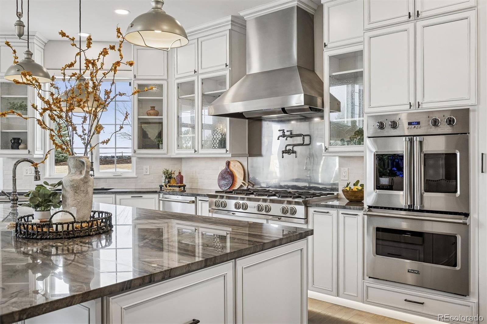 337 High Ridge Way Castle Pines, CO 80108 - Photo 16 of 50 a kitchen with stainless steel appliances granite countertop a stove and a sink