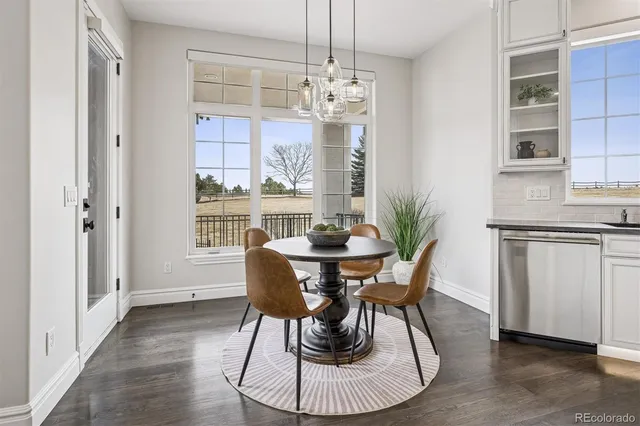 a view of a dining room with furniture and wooden floor