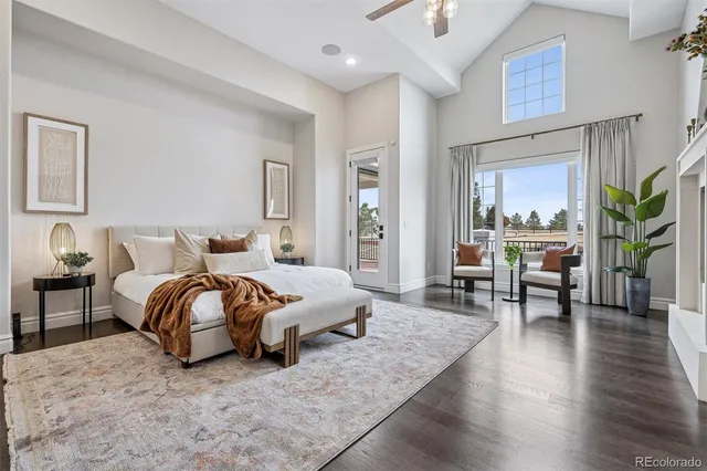 a living room with furniture a large window and a fireplace