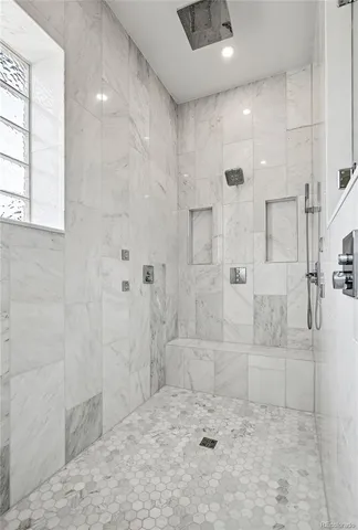 a spacious bathroom with a double vanity sink a mirror a bathtub and shower