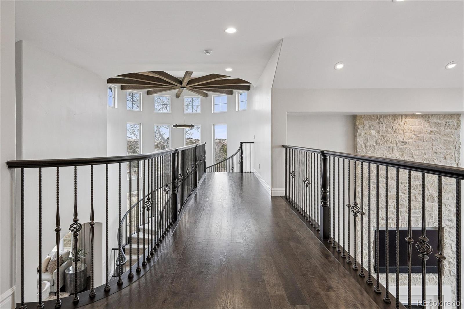 337 High Ridge Way Castle Pines, CO 80108 - Photo 31 of 50 a view of a hallway with wooden floor and furniture