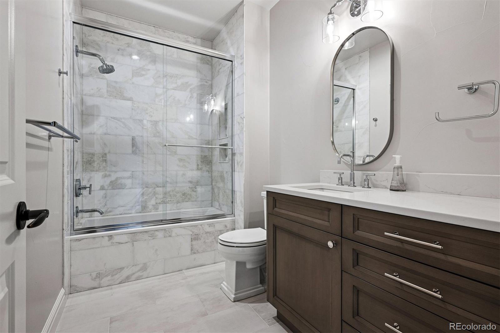 337 High Ridge Way Castle Pines, CO 80108 - Photo 38 of 50 a bathroom with a double vanity sink toilet and shower