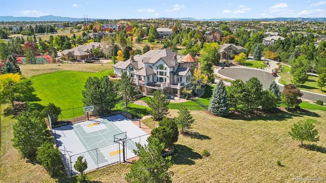 an aerial view of a house with a yard