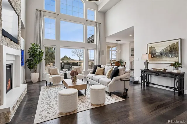 a living room with fireplace furniture and a large window