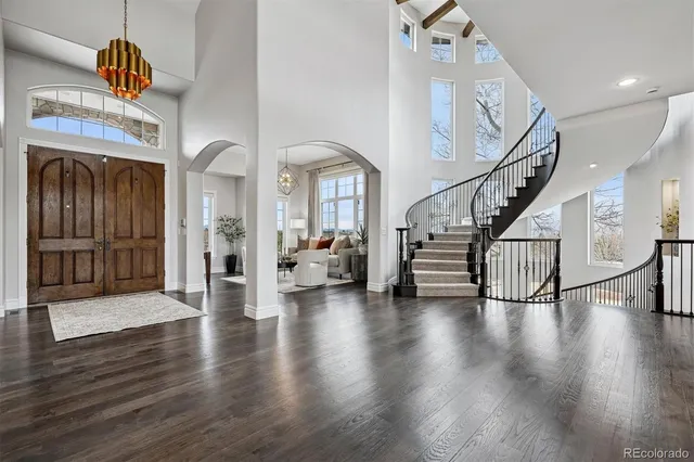 a living room with furniture chandelier and a window