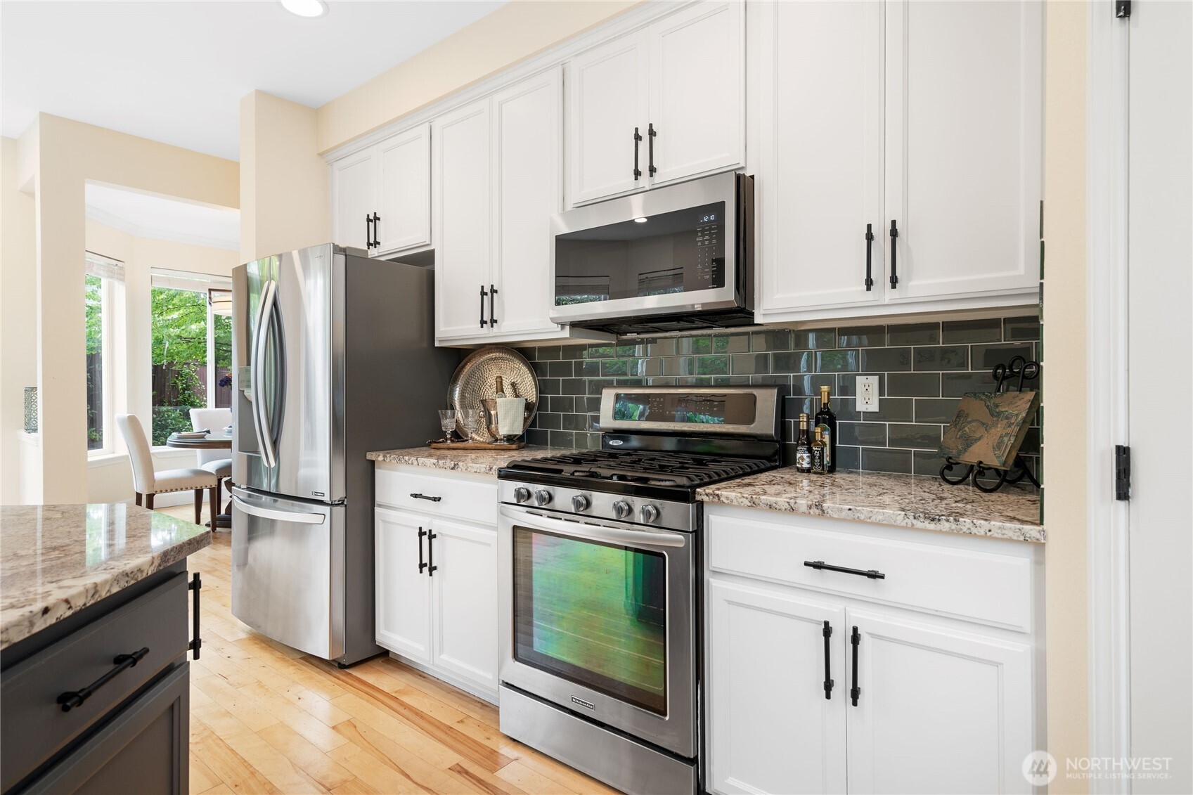 21104 1st Avenue West Bothell, WA 98021 - Photo 13 of 34 a kitchen with stainless steel appliances granite countertop a stove a refrigerator and a microwave