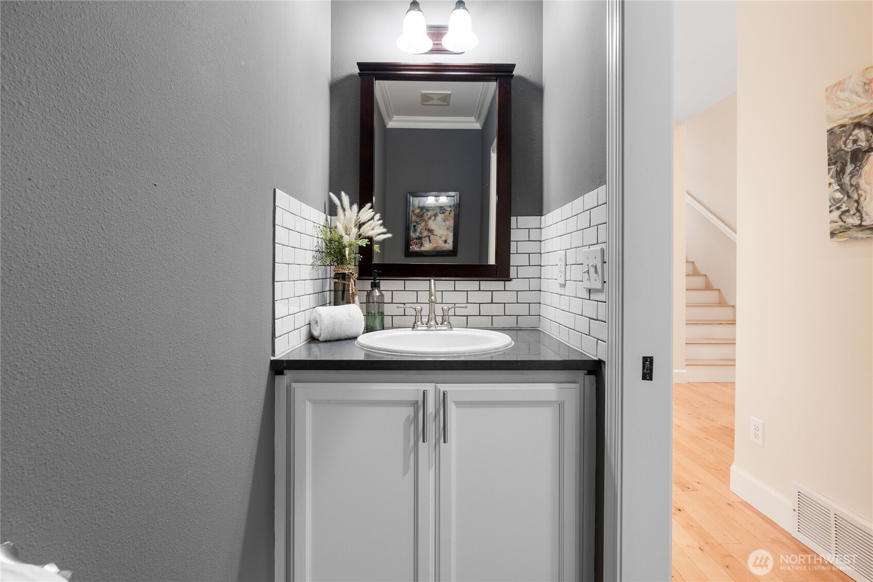 21104 1st Avenue West Bothell, WA 98021 - Photo 18 of 34 a bathroom with a granite countertop sink a mirror and a vanity