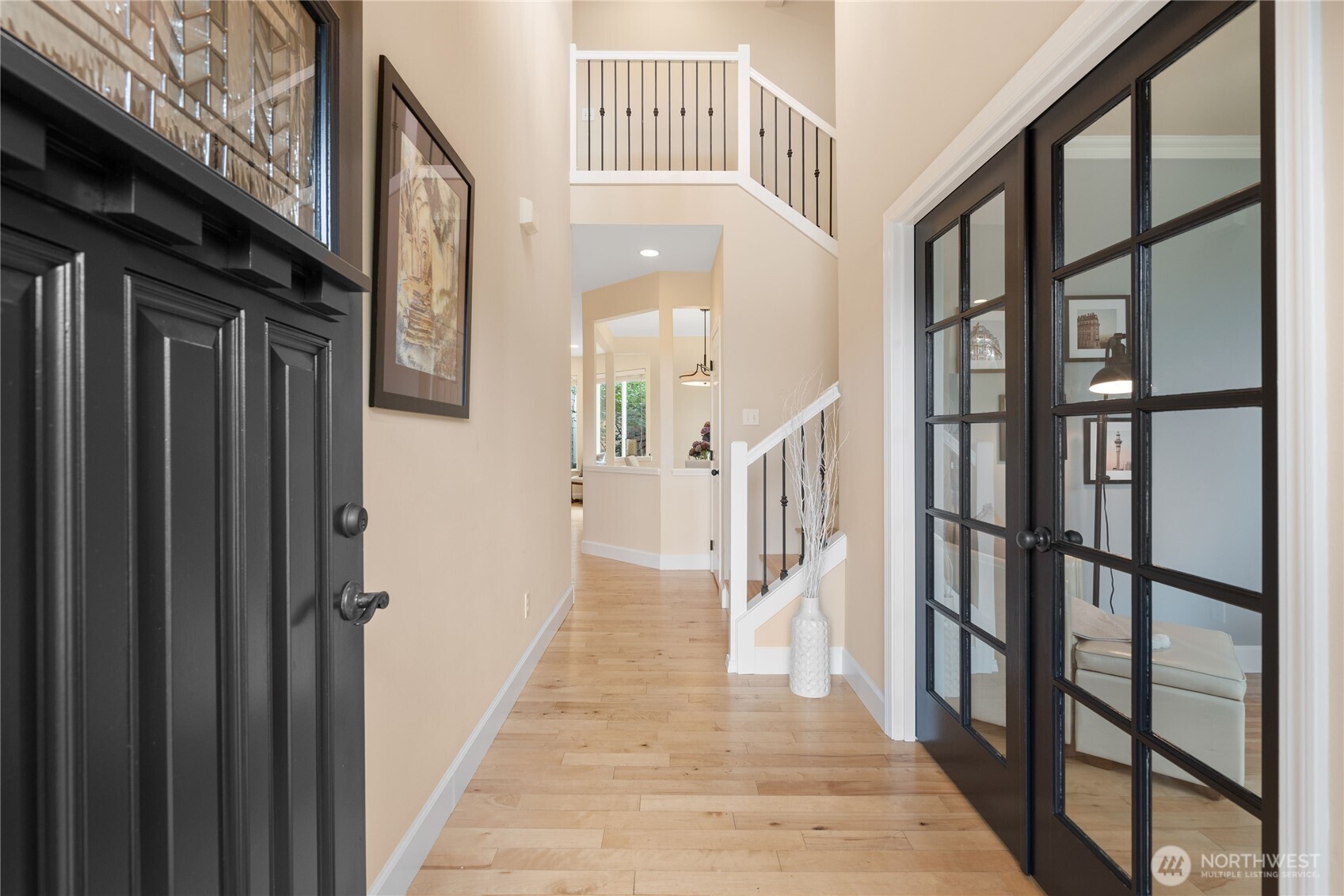 21104 1st Avenue West Bothell, WA 98021 - Photo 4 of 34 a view of a hallway with wooden floor and staircase