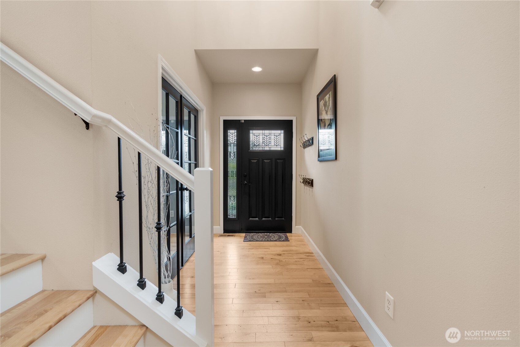 21104 1st Avenue West Bothell, WA 98021 - Photo 5 of 34 a view of a hallway with wooden floor and entryway