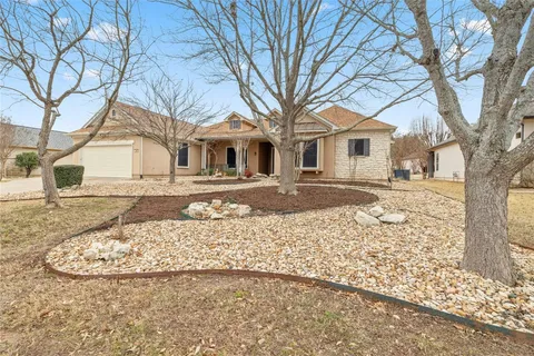 a front view of a house with a yard covered in snow