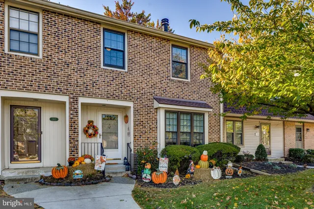a front view of a house with outdoor seating