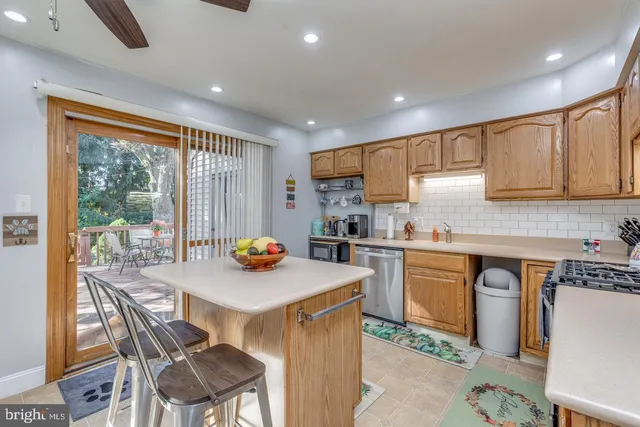 a kitchen with a stove a refrigerator and a dining table