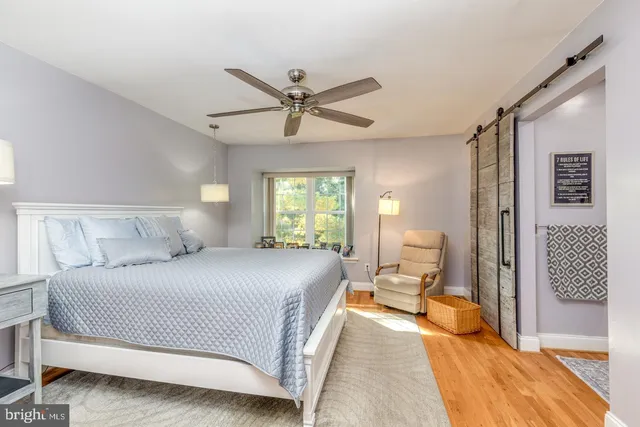 a bedroom with a bed couch and window