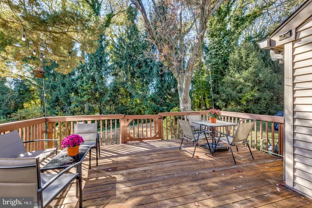 a view of a deck with chairs and wooden fence