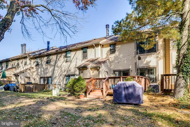 a wooden bench sitting in front of a building