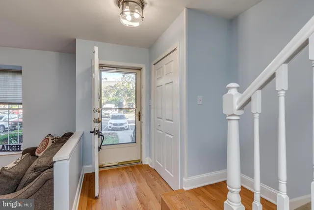 a view of a hallway with workspace and wooden floor