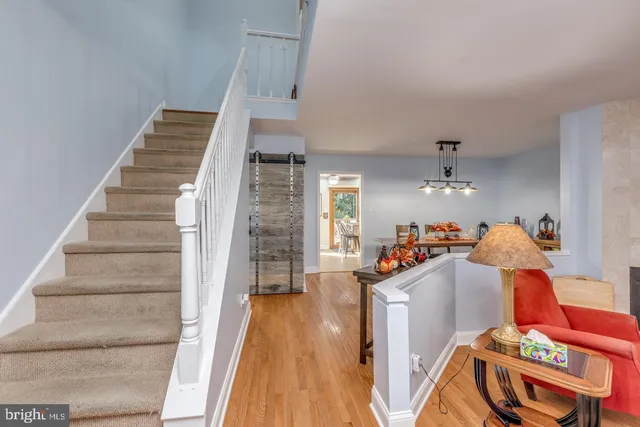 a view of entryway and hall with wooden floor