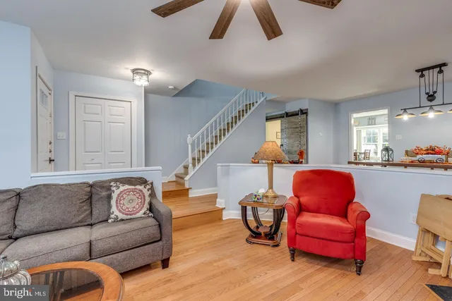 a living room with furniture with kitchen view