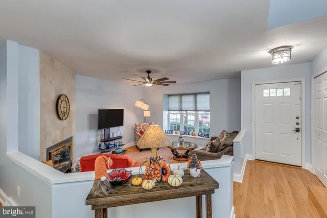 a living room with furniture a flat screen tv and a window