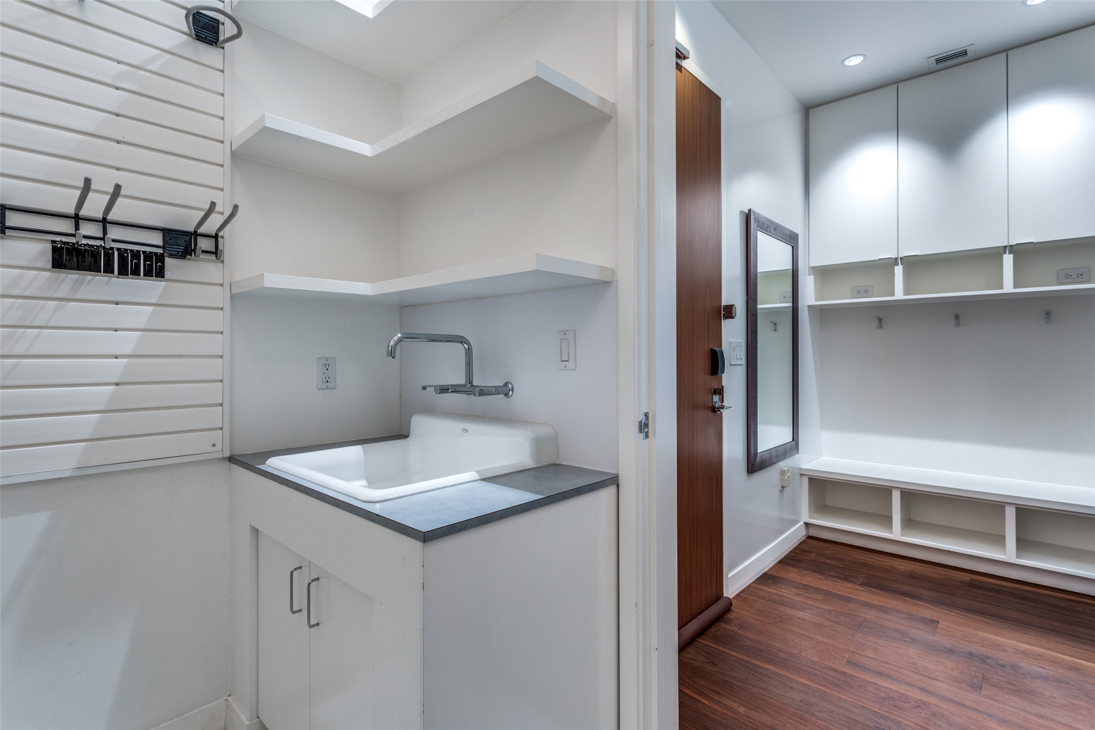 210 Lavaca Street, Unit 3305 Austin, TX 78701 - Photo 19 of 24 Laundry area with dark wood finished floors and a sink
