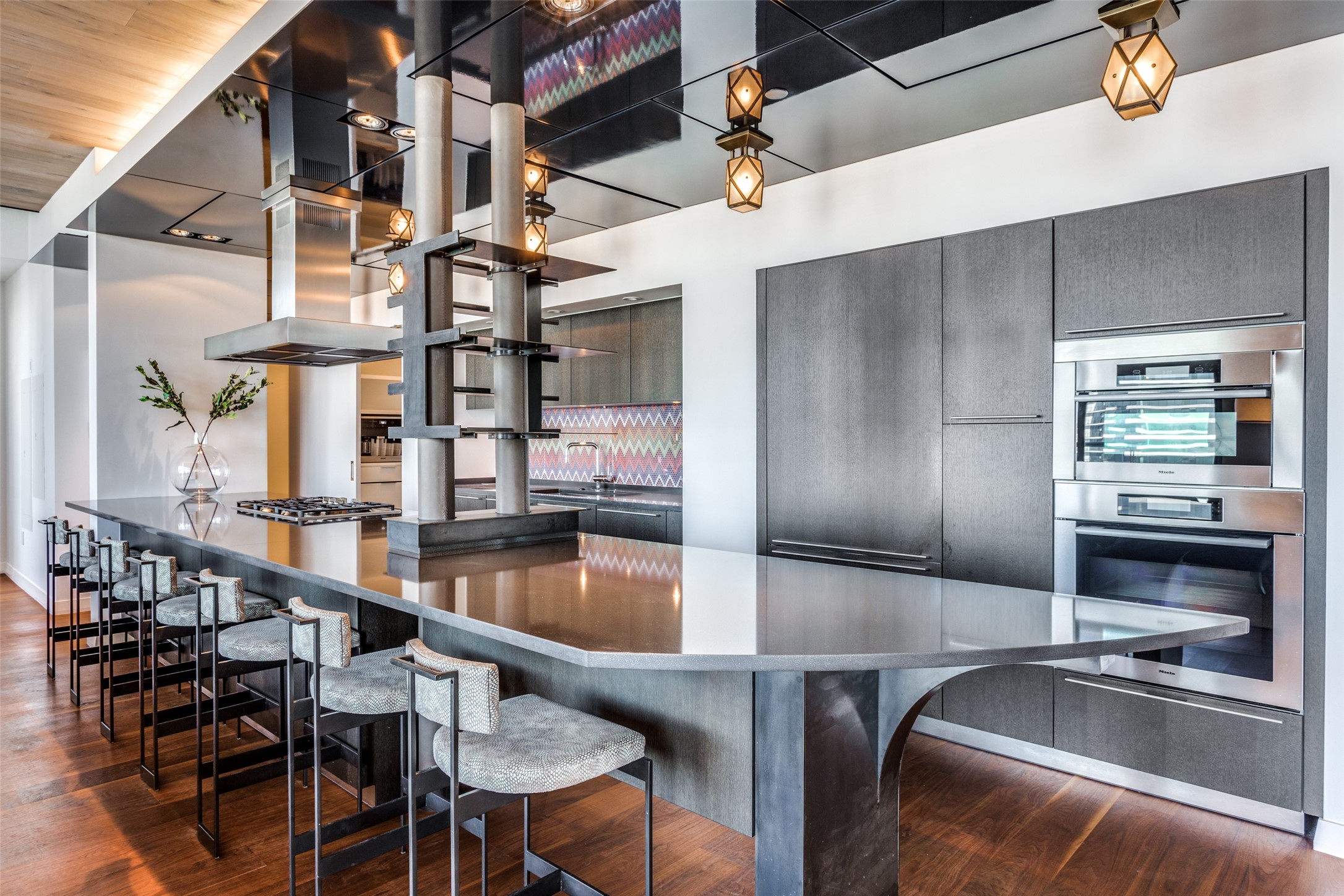 210 Lavaca Street, Unit 3305 Austin, TX 78701 - Photo 2 of 24 Kitchen with stainless steel appliances, dark wood-type flooring, extractor fan, modern cabinets, and a kitchen breakfast bar