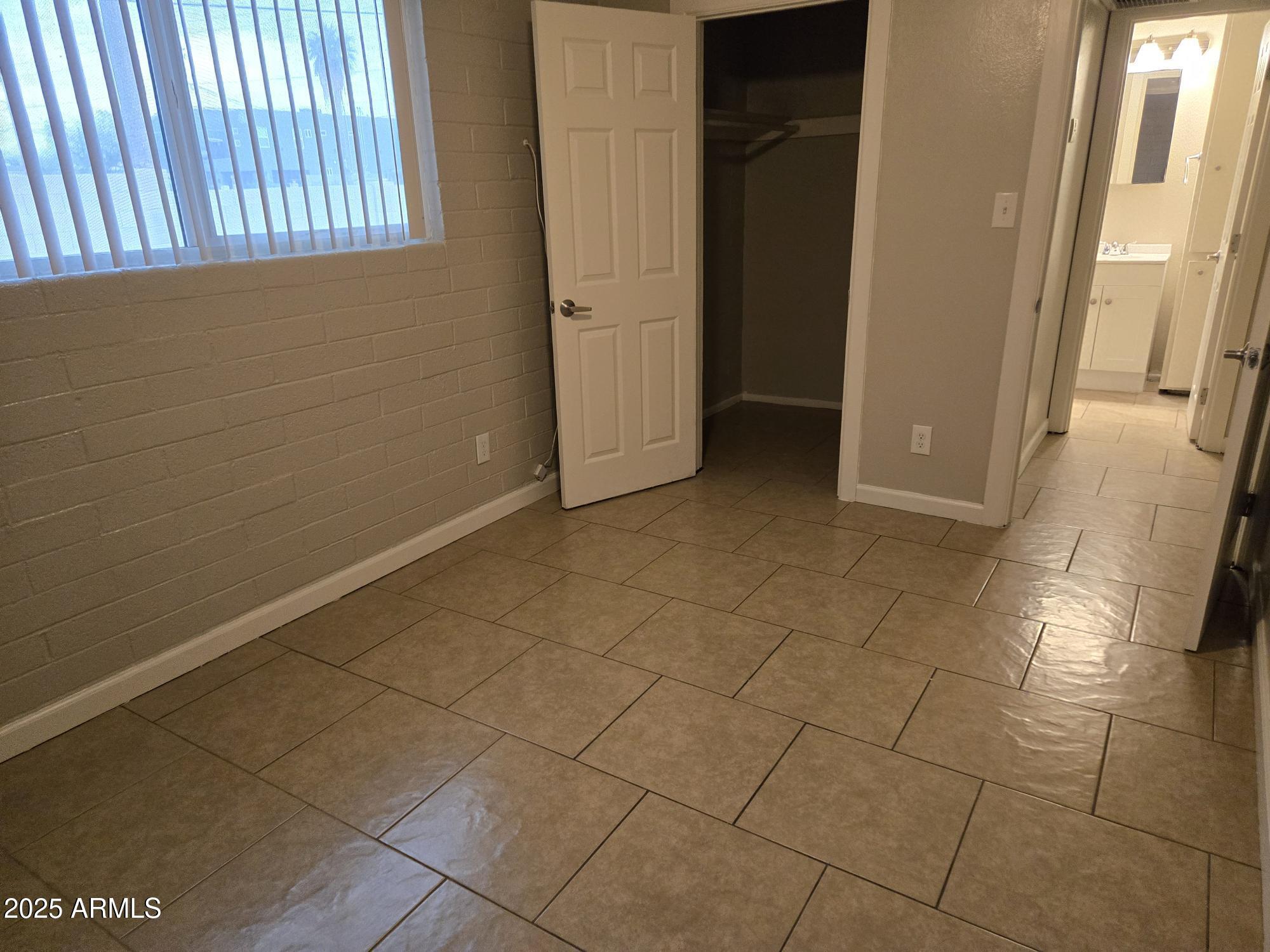 902 East Southern Avenue, Unit 2 Phoenix, AZ 85040 - Photo 13 of 25 a view of a livingroom with an empty space and a window