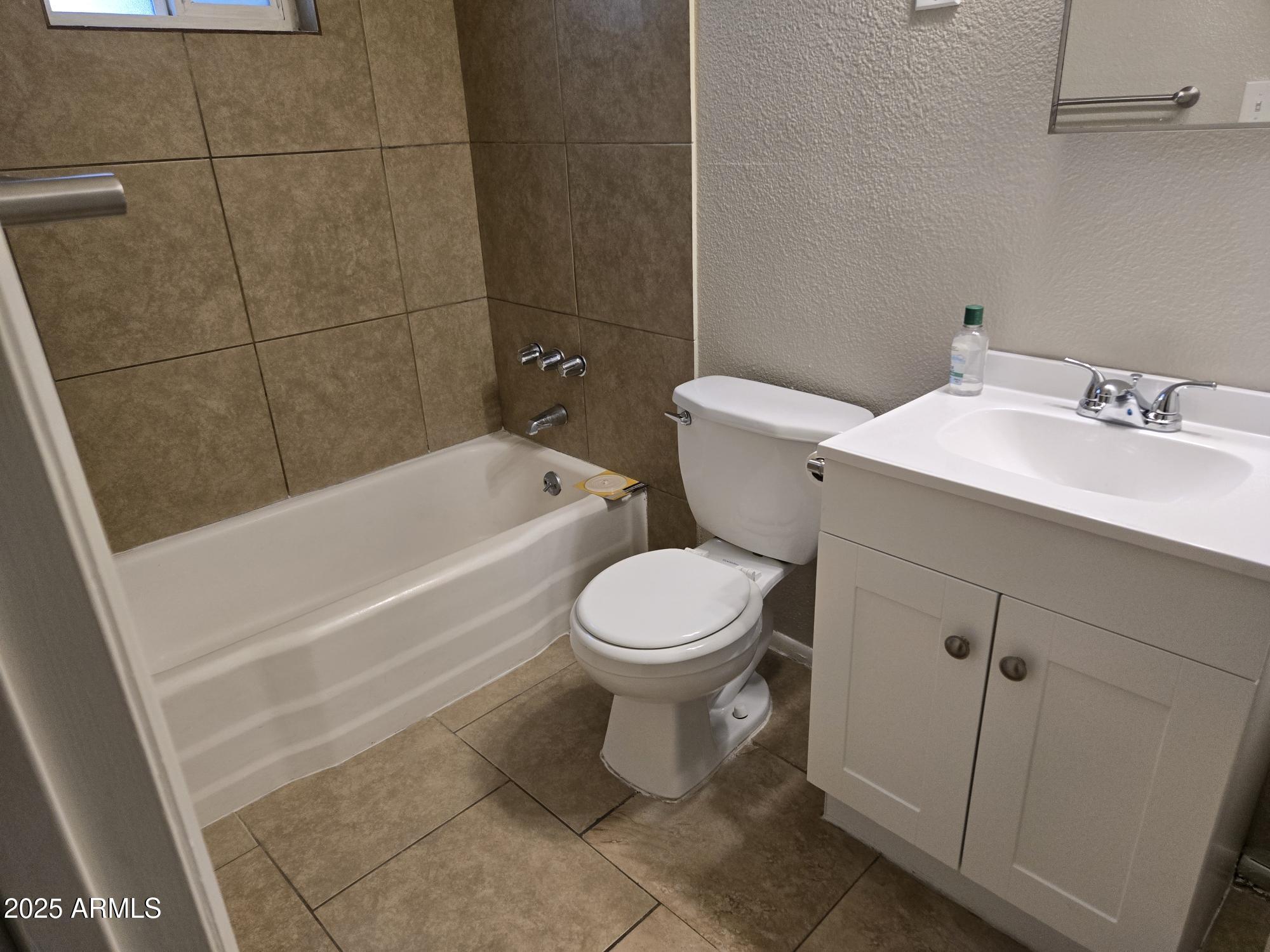902 East Southern Avenue, Unit 2 Phoenix, AZ 85040 - Photo 22 of 25 a bathroom with a sink a toilet and bathtub