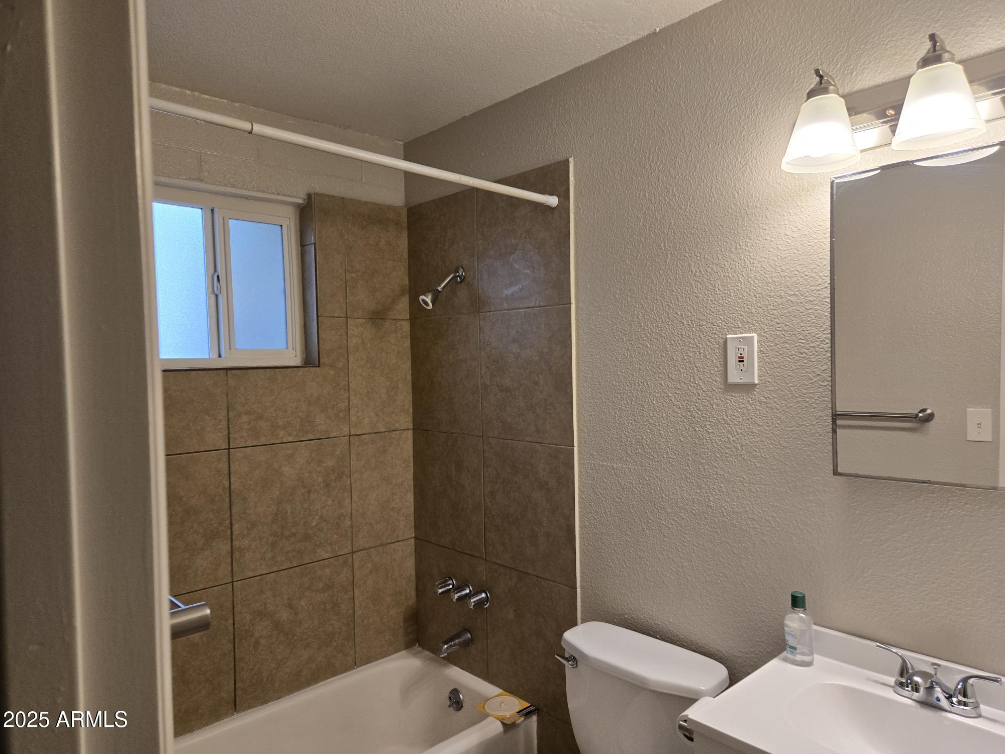 902 East Southern Avenue, Unit 2 Phoenix, AZ 85040 - Photo 23 of 25 a bathroom with a sink a toilet and shower