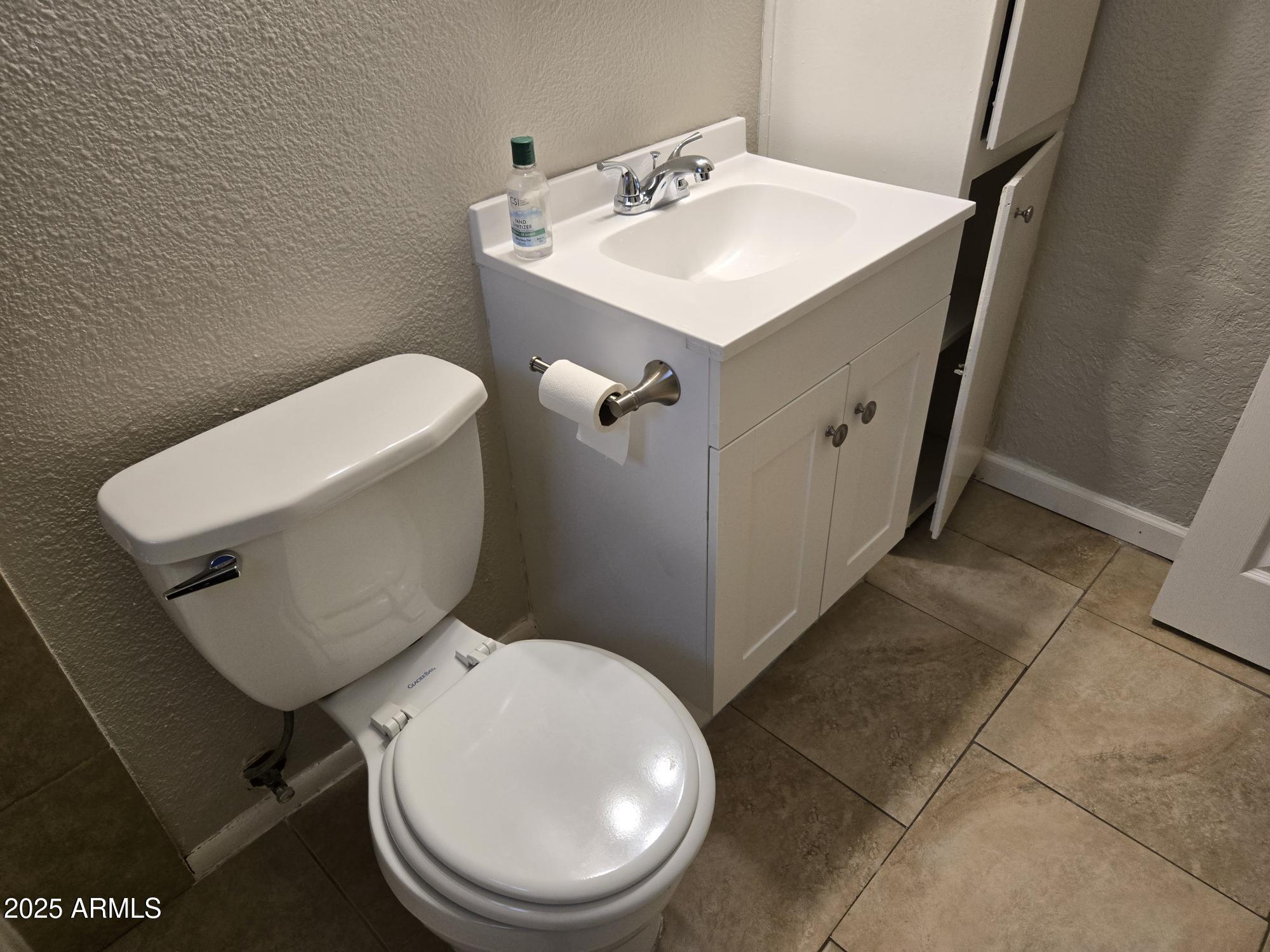 902 East Southern Avenue, Unit 2 Phoenix, AZ 85040 - Photo 25 of 25 a white toilet sitting next to a bathroom sink