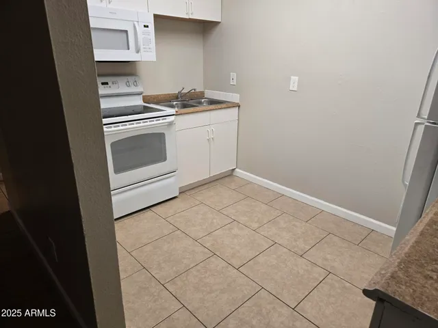 a kitchen with white cabinets