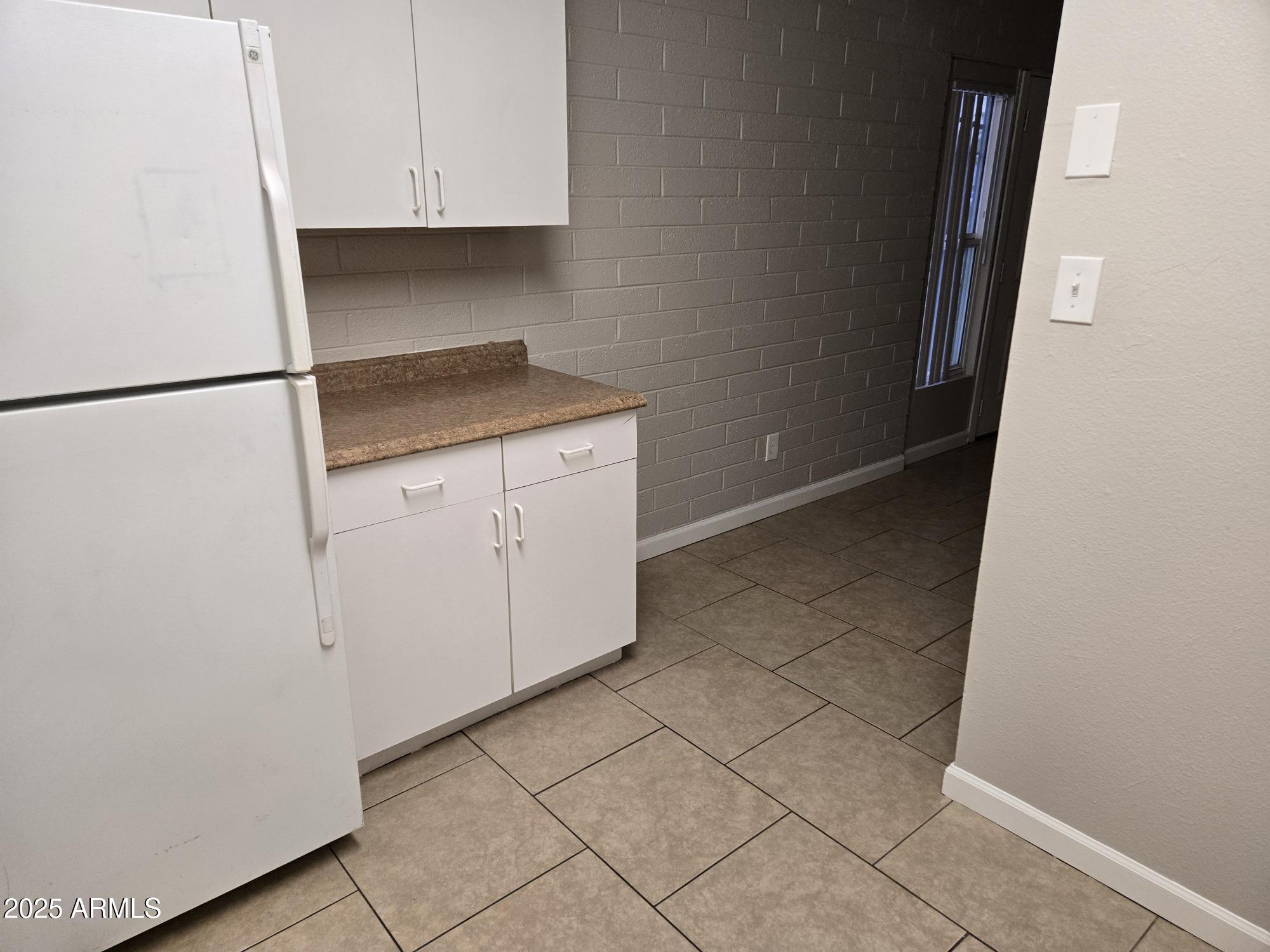 902 East Southern Avenue, Unit 2 Phoenix, AZ 85040 - Photo 5 of 25 a kitchen with white cabinets