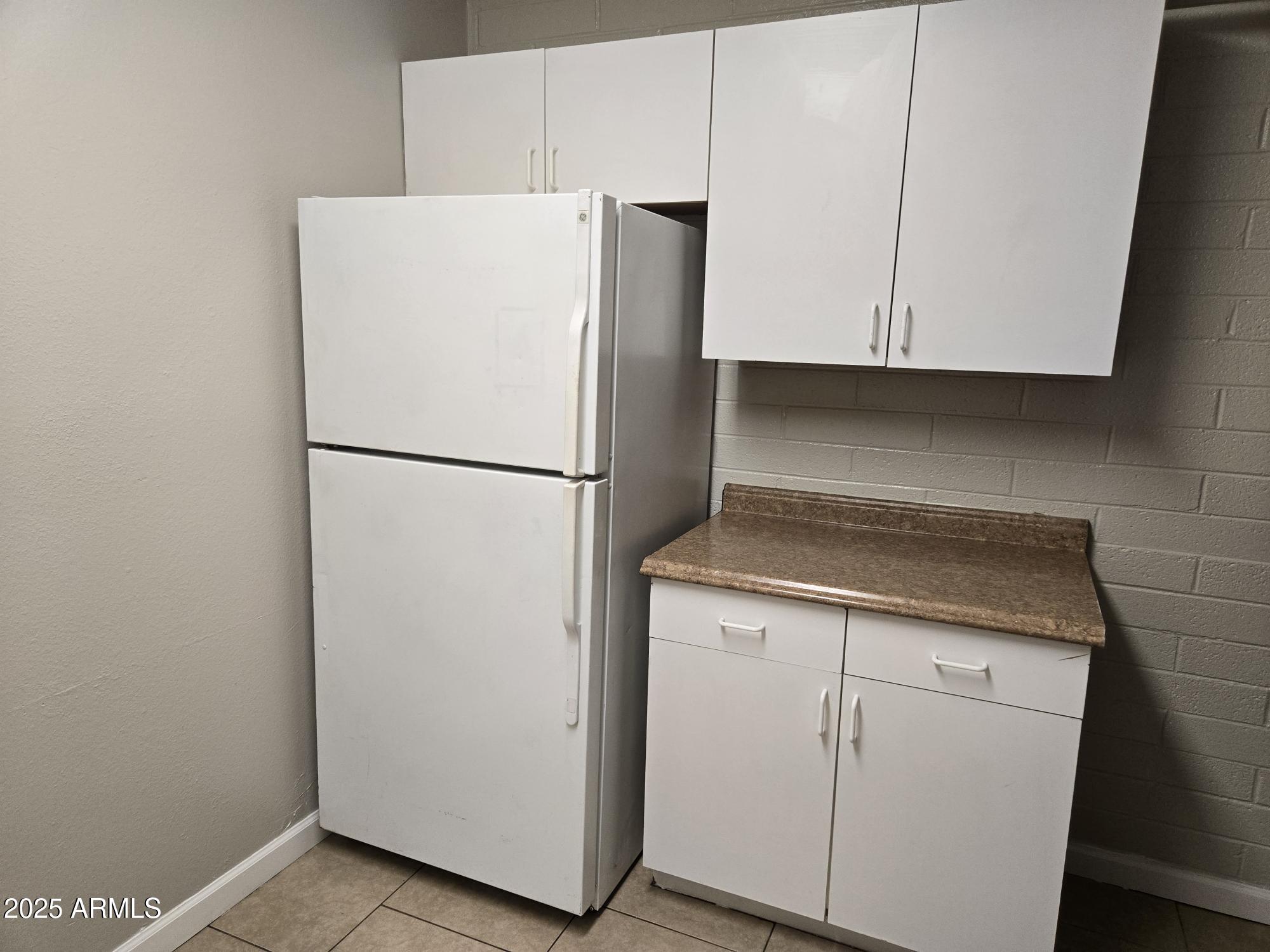 902 East Southern Avenue, Unit 2 Phoenix, AZ 85040 - Photo 6 of 25 a white refrigerator freezer and a stove sitting inside of a kitchen