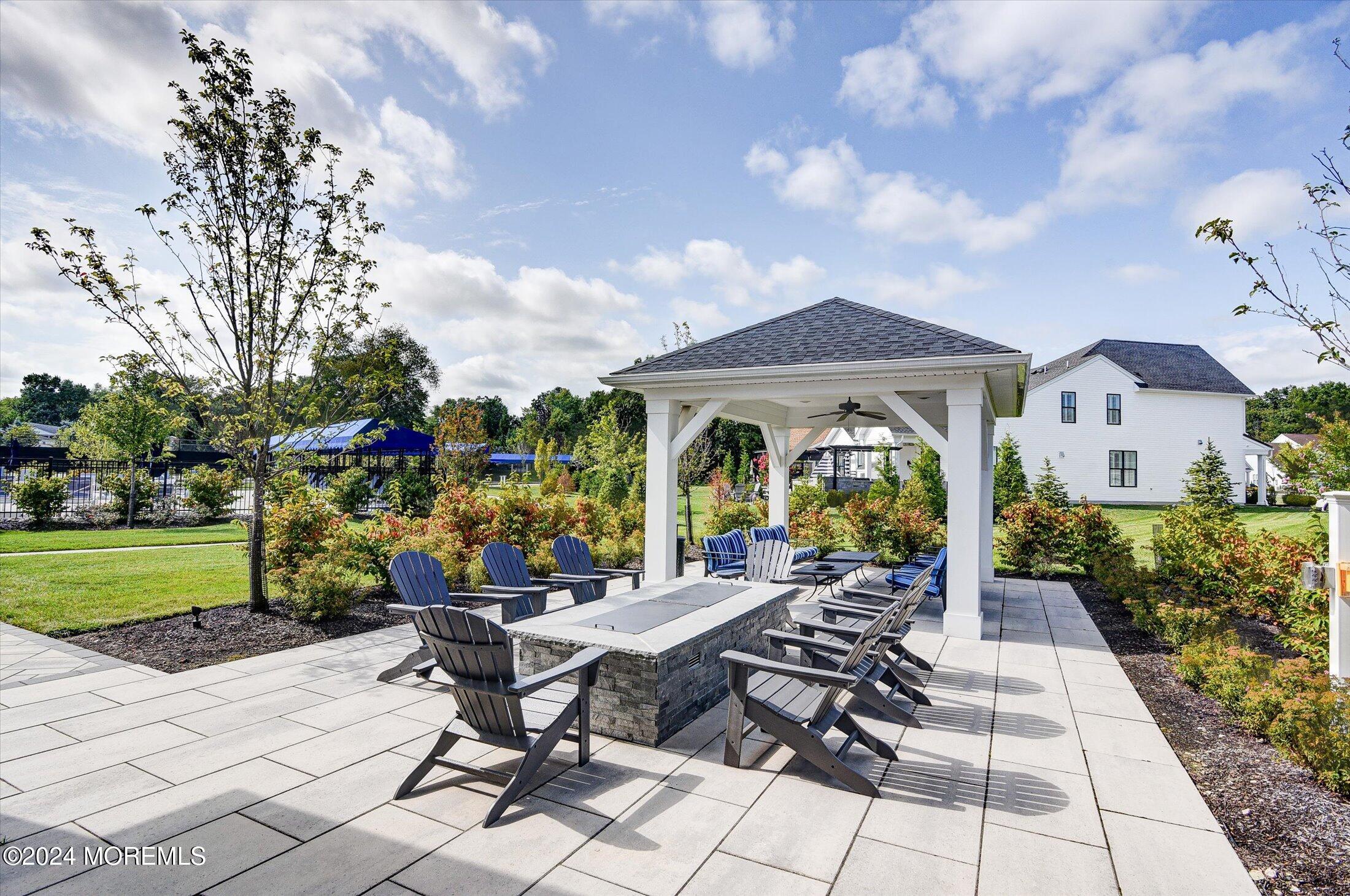 166 Grandview Circle Howell, NJ 07731 - Photo 43 of 48 a view of a patio with table and chairs potted plants and large tree