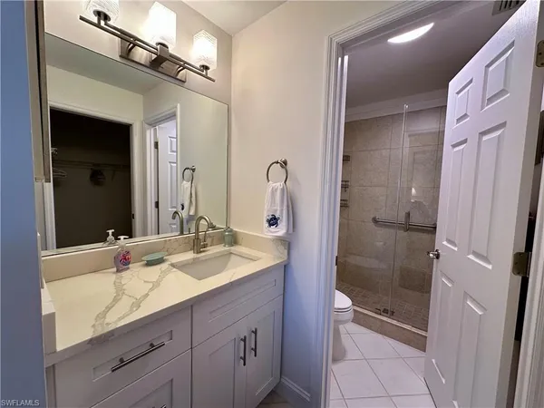 a bathroom with a shower sink and mirror