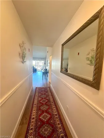 a view of hallway with wooden floor